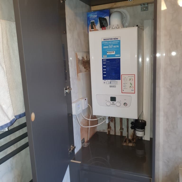 Home gas boiler instaled in a cupboard in a bathroom